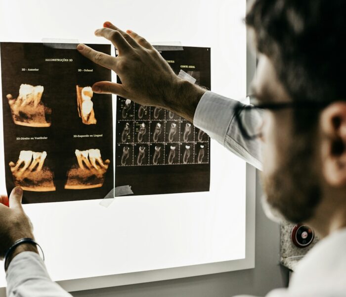 person in gray long sleeve shirt holding black tablet computer